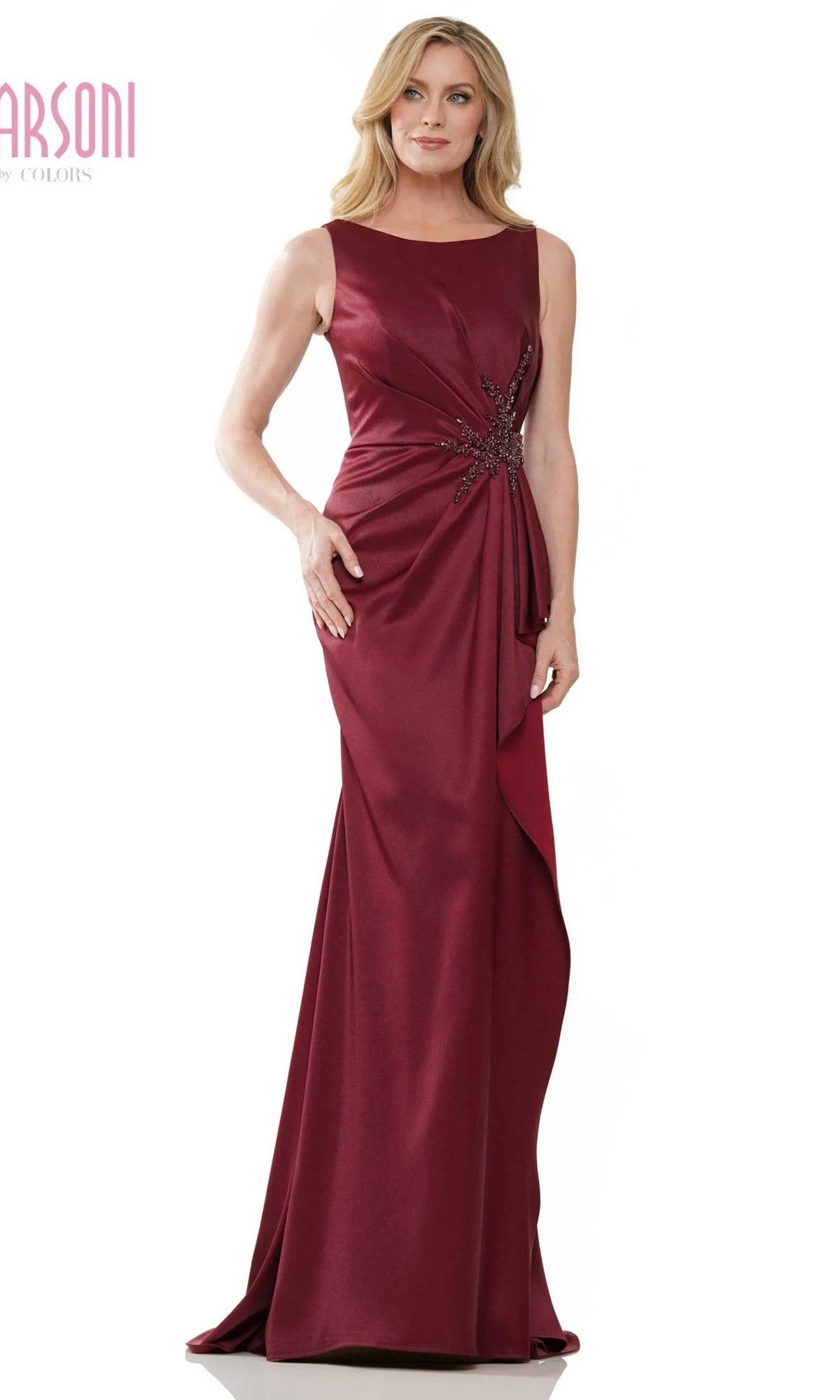 A woman stands and smiles in the Long Formal Dress: Marsoni MV1233, a sleeveless, floor-length gown in wine with beaded waist embellishments, set against a plain background.